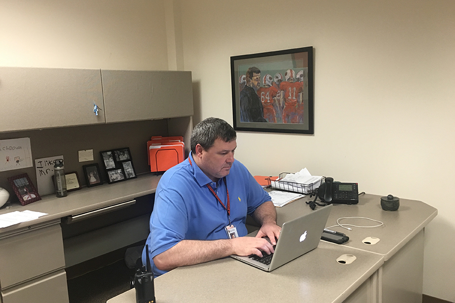 Athletic director Andrew Ewald works in his office in preparation for the end of the spring sports season.