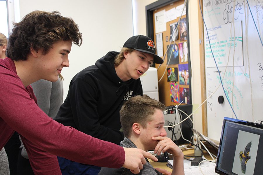 Juniors Ryan Klaers, Jonny Sorenson and Skyler-Rudelius Palmer create mock yearbooks for the Echowan editor applications. The interview process began April 13 and will end April 24.