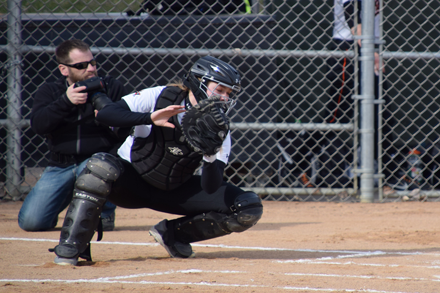 Sophomore+catcher+Maddy+Schmitz+catches+the+softball+during+team+warmups+before+a+game.+Sections+are+set+to+start+May+22.+++