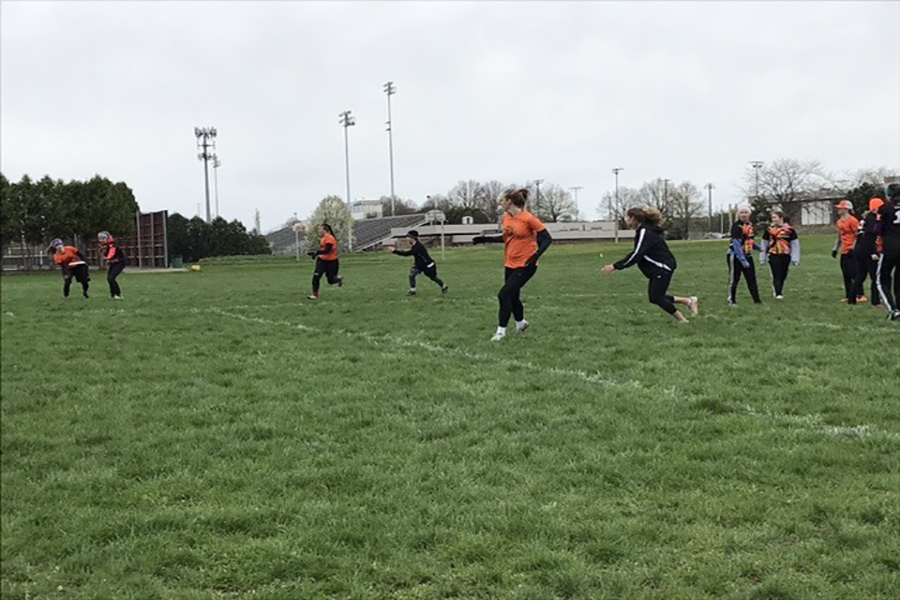 Senior Ruthie Hope and Junior Hanna Schechter run to defend the disk Saturday, April 29 during the Madison Mudbath tournament in Madison, Wisconsin.