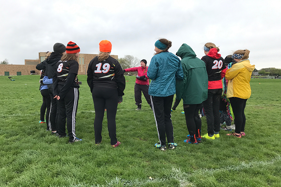 Coach Seija Stratton explains plays to the team during a timeout in game four of Madison Mudbath. The girls team played 5 games on Saturday, April 29. Due to the weather forcast for Sunday, April 30, tournament leaders decided to have all teams play all their games on Saturday, April 29.
