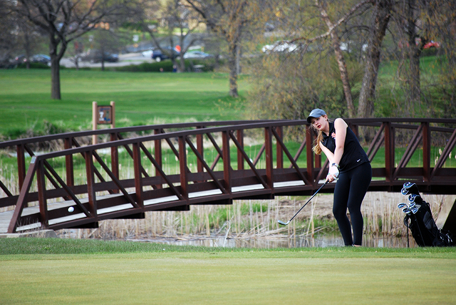 Junior Martha Walton follows through on her shot at the Brookview golf course at the girls golf match on Thursday, May 4.