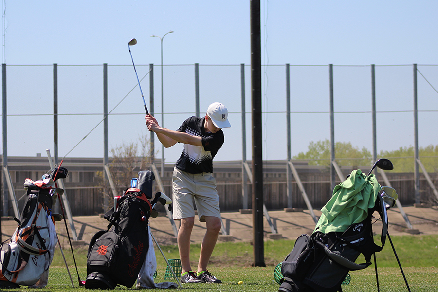 Senior Otis Walvatne winds up for a short iron shot on the Brookview driving range. Walvatne said his goal his goal for the season includes making the state tournament and for the team to reach top four ranking in the conference. 