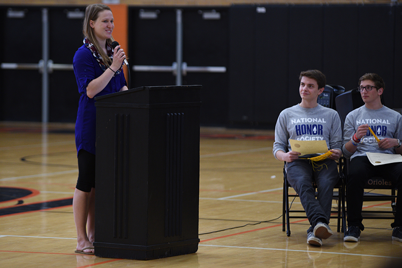 Adviser Jill Merkle opens the induction ceremony on May 19 in the old gym.