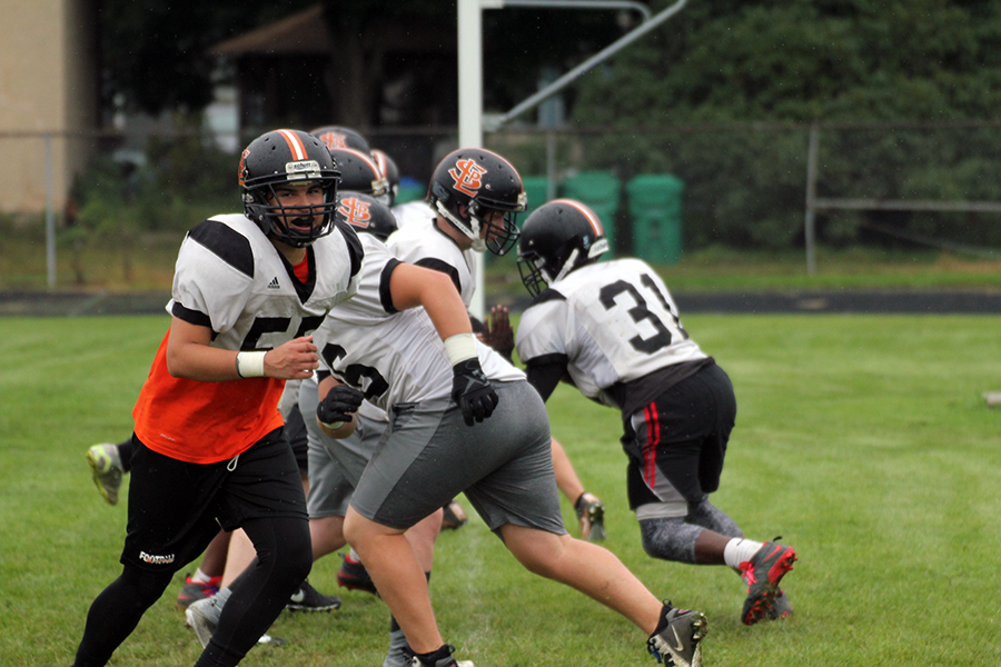 Football players prepare on August 18 at the practice field for the upcoming season.