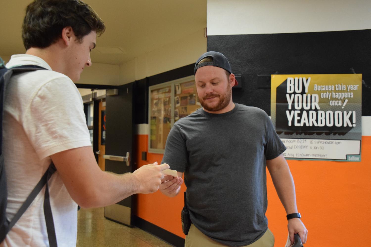 Senior Ryan Klaers gets his ID checked at the C doors Sept. 12. 