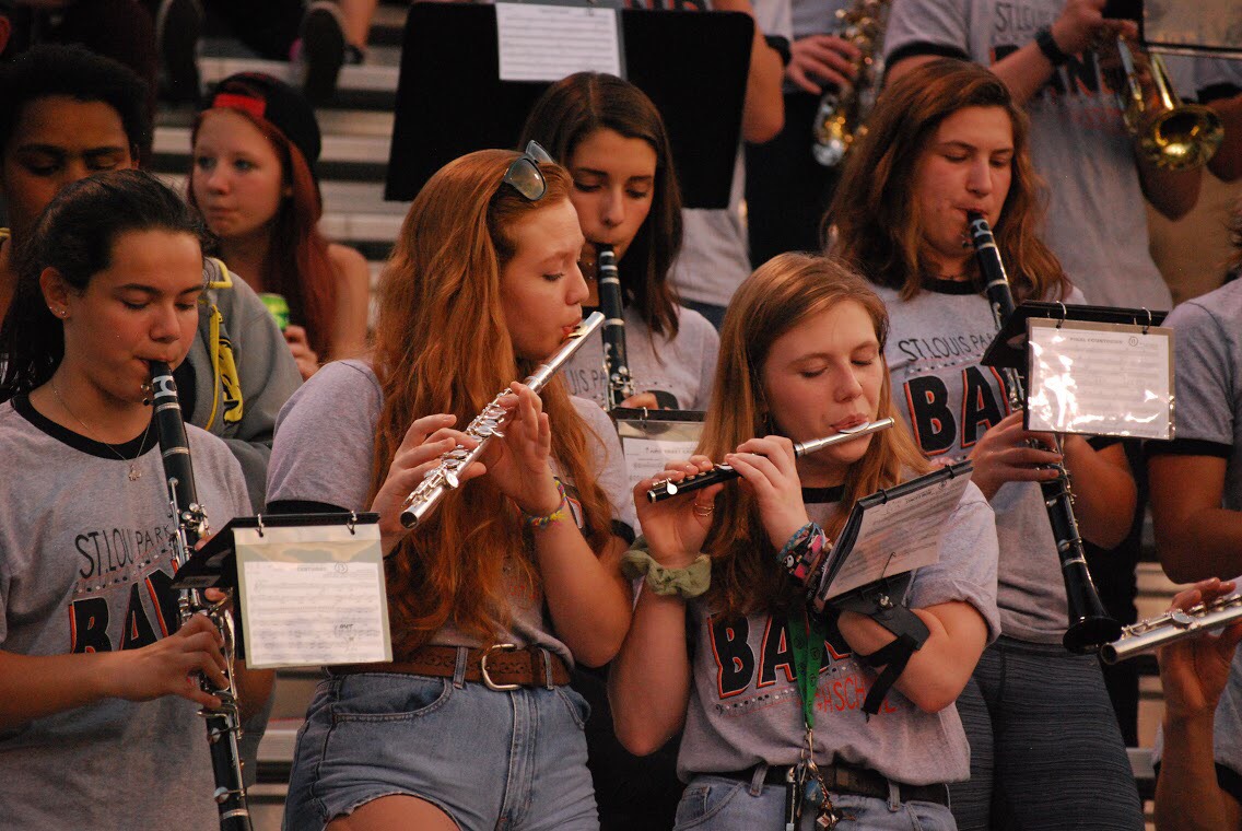 Juniors Morgana Orberdorfer, Ana Armbrecht, and Rachel Mattson play in the pep band during the homecoming game Sept. 15.