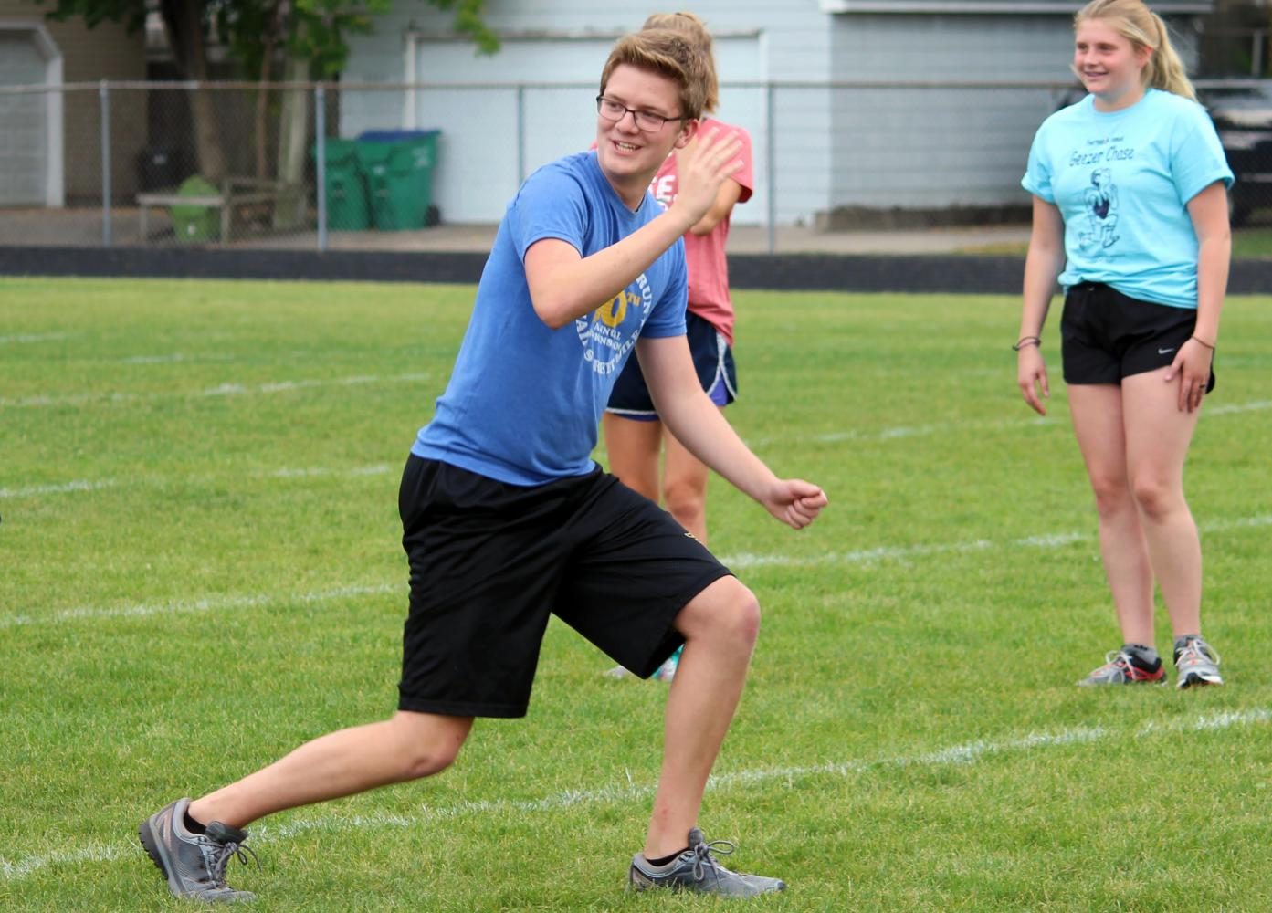 Senior Collin Perkins leads warm ups at the start of cross country practice Sept. 15.