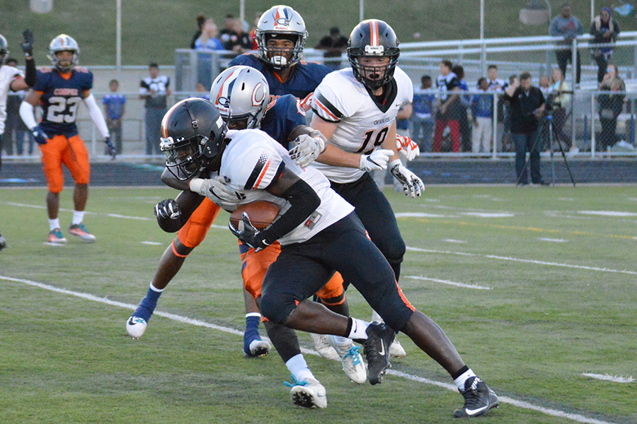 Sophomore Skylor Glover charges through Cooper defender to the end zone. The Orioles next game is Sept. 15 against Academy of Holy Angels. 