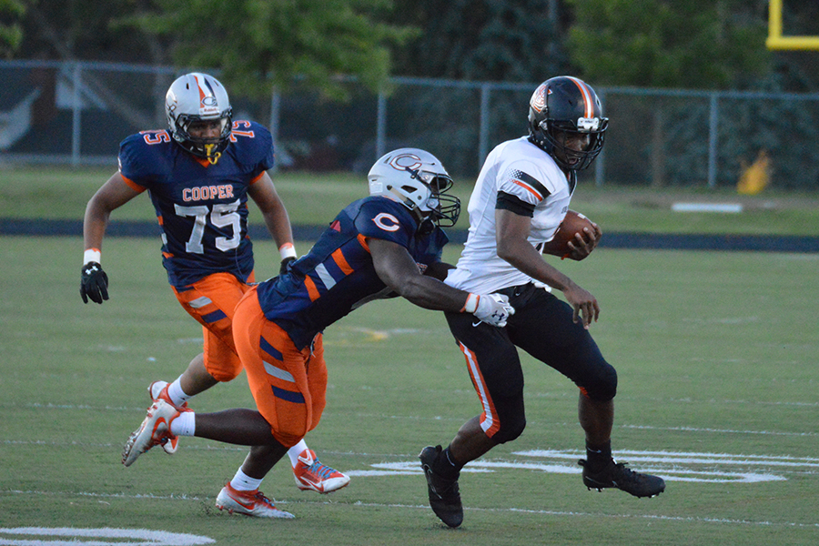 Sophomore Sajid Nathim carries the ball past Cooper defense. Orioles fell to the Hawks 40-14.