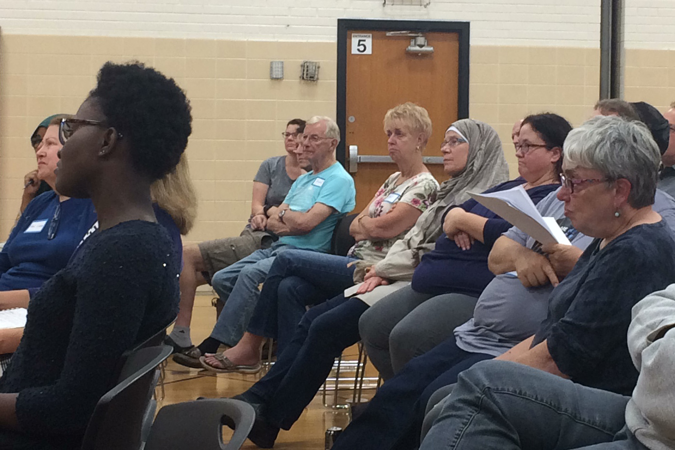 Park community members attentively listen to a speaker at a community meeting led by Muslim leaders, Sept. 19.