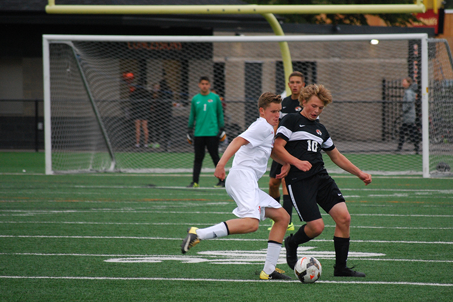 Senior Kyle Hedblom attempts to get the ball around the New Richmond defense. Hedblom played 