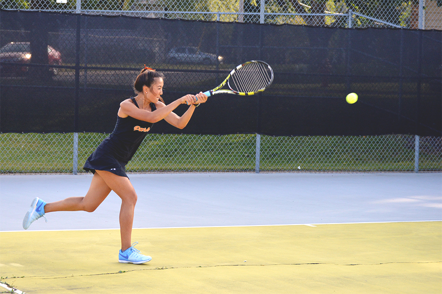 Junior Susi Hu hits a cross-court backhand against Robbinsdale Cooper. Hu has been on the team for three years and plays in the fourth singles spot. 