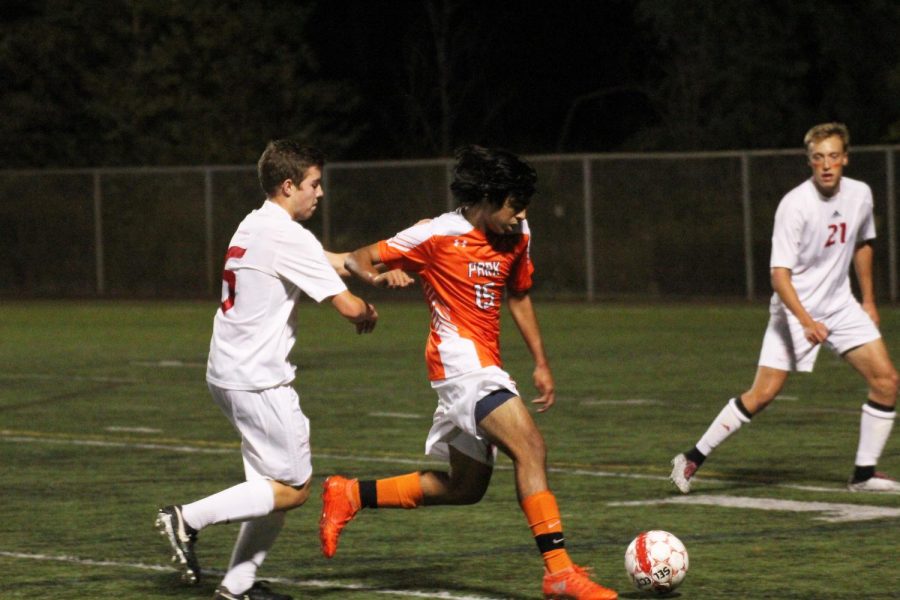 Junior Fabio Leyva dribbles past a Benilde-St. Margarets player during the Oct. 5 game. Park won the game 2-0, putting the boys varsity team in first place in their conference.
