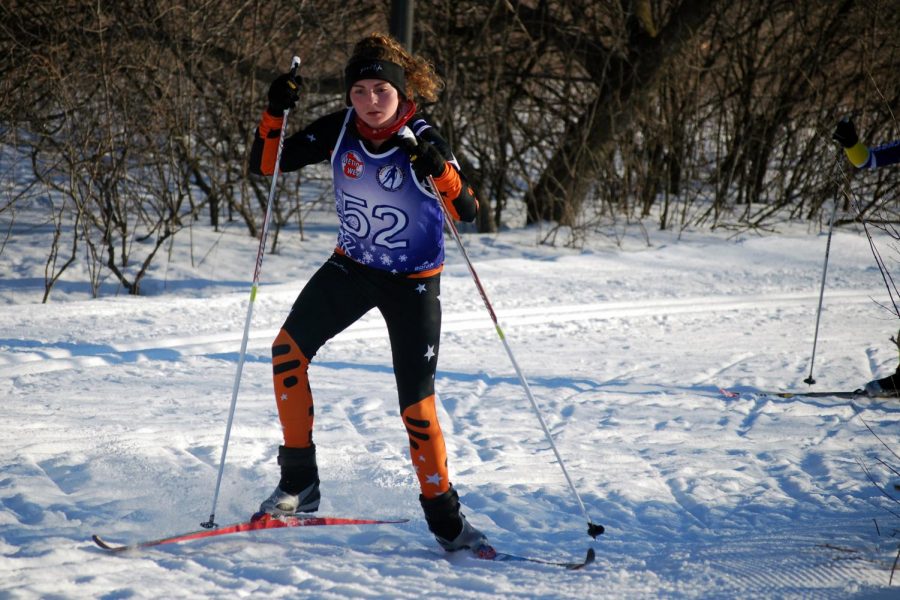 Junior Emma Peterson skis her way up a hill during JV Champs last January. Nordic captains practices start Nov. 6.
