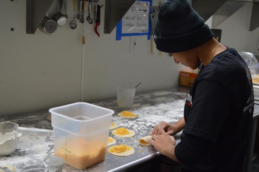 Senior Sabrina Garcia assembles an empanada, a latin american pastry. Garcias goal is to make 300 empanadas a day.