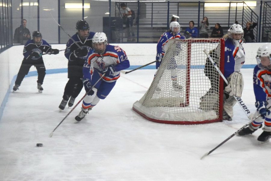 Freshman Erin Brousseau moves the puck away from Park-Hopkins goal. The team played 7:00 on Tuesday Nov. 28 against Rogers. 