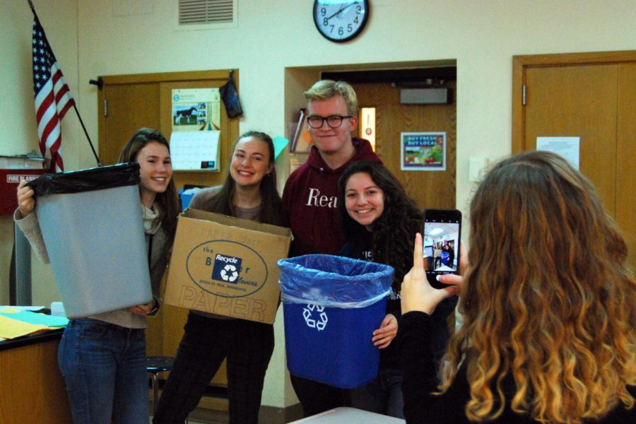 Recycling committee members, all juniors, Anika Hansen, Emma Kempf, Casey Kreie, and Leila Raymond pose for a Roots and Shoots photo at the meeting on  Nov. 7.