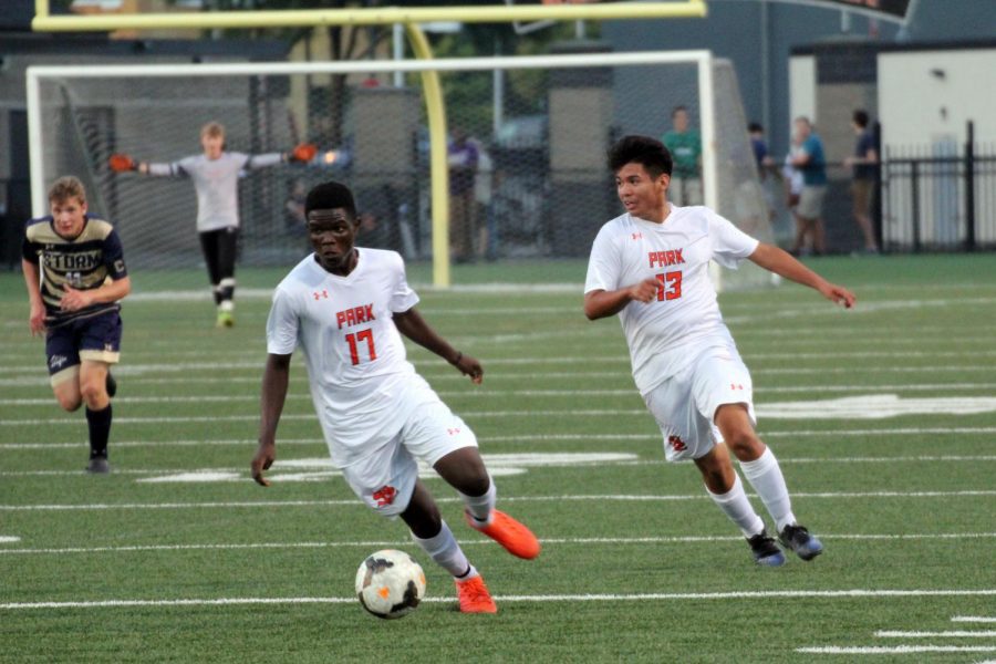 Seniors Randy Mayele and Antonio Olivas-Reyes work to get the ball away from their side of the field. Park soccer played Chanhassen Sept. 14.  