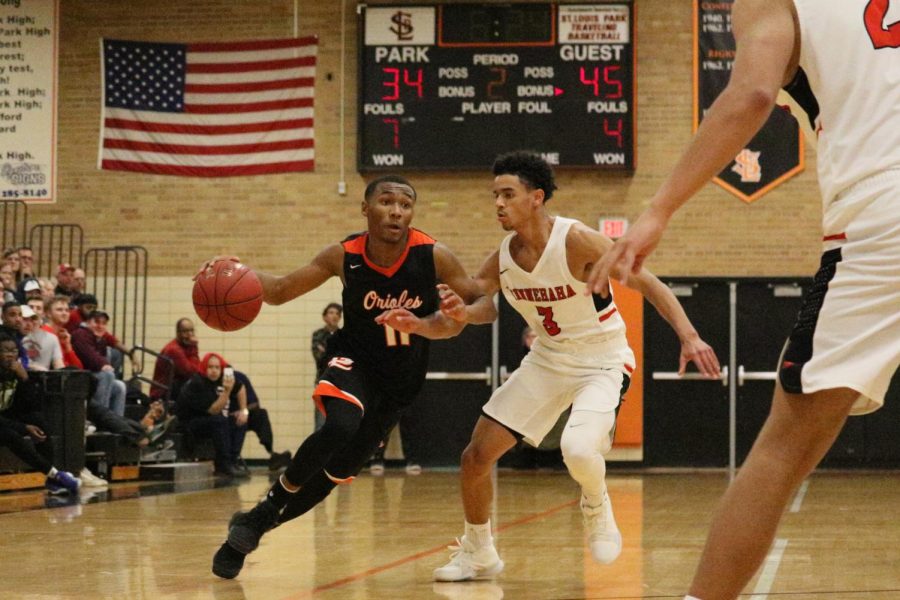 Mayfield drives the basketball to the basket against a defender. Mayfield leads the team in scoring (16.7 ppg), assists (6.0 apg), rebounding (6.3 rpg), and steals (2.2 spg).