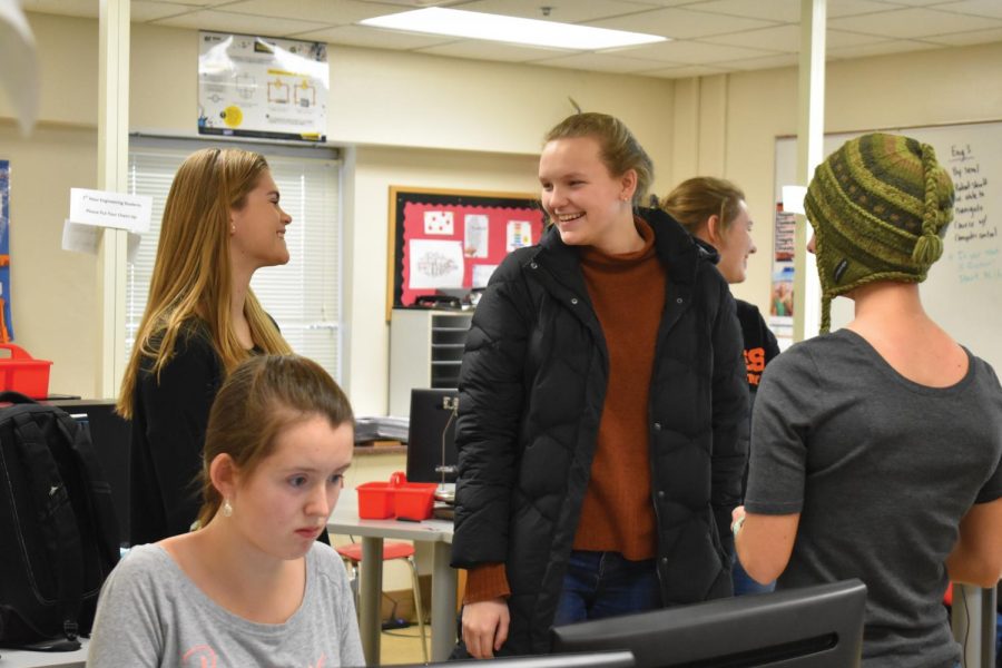 Juniors Sophia Davenport, Ilsa Olsen and Caroline Garland gather to discuss their plan for the coming Technovations year. They work for 12 weeks during the school year before presenting their app in May.