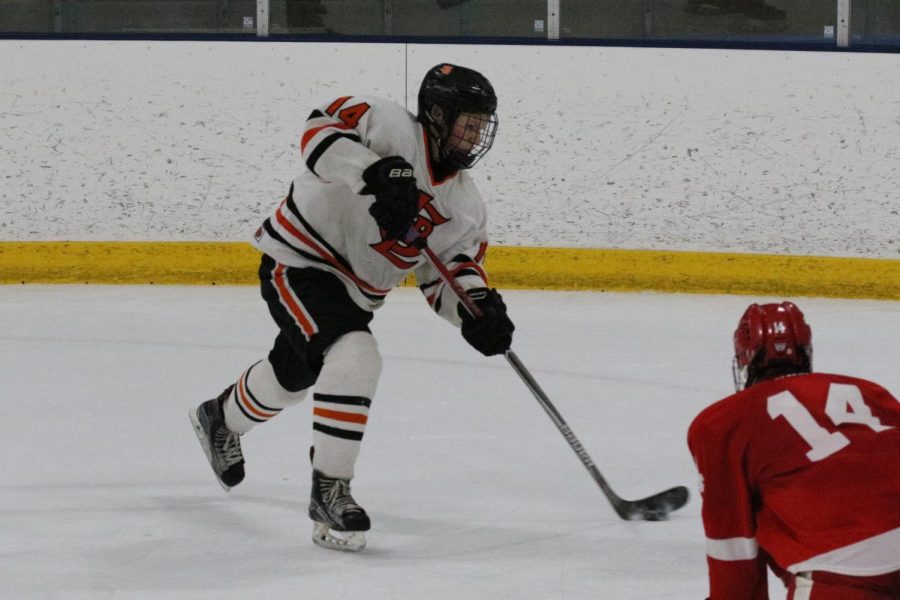Sophomore Avery Pittman takes a wrist shot in his game against Benilde