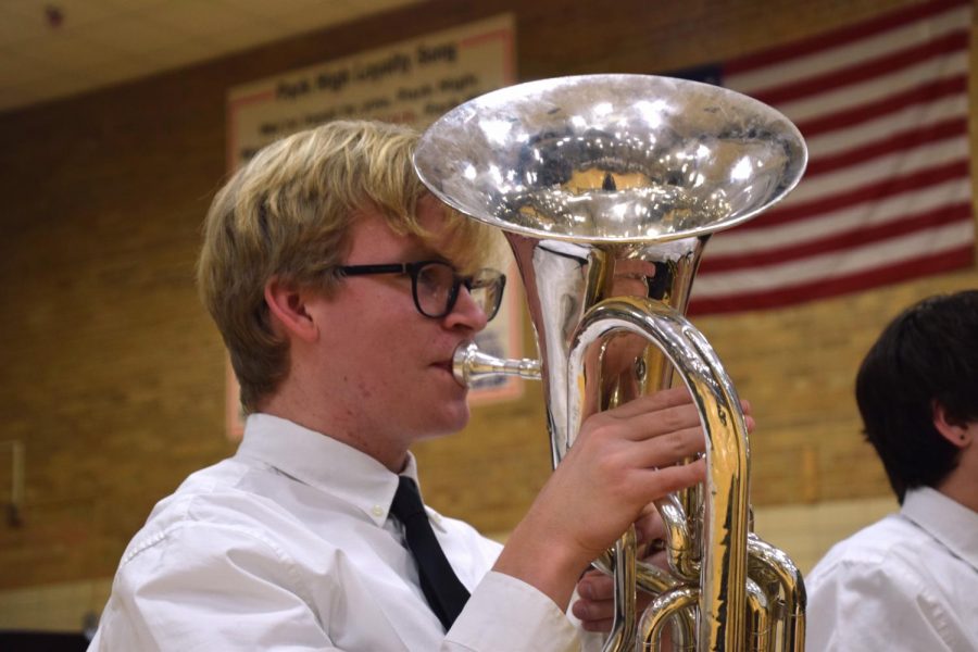 Junior Casey Kreie plays the baritone at the annual district band concert Feb. 26. Fifth graders, eighth graders and the high school Wind Ensemble perform together in the high school gym.