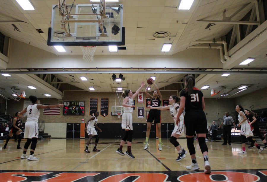 Freshmen Kendall Coley shoots over defender from Chaska during the game on Feb. 15. The Orioles win 71-61.