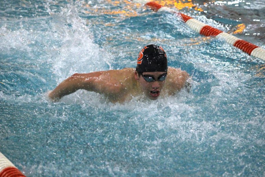 Freshman Hayden Zheng competes in his race during senior night, the final home meet of the season against Benilde on Feb. 2. Hayden broke the 100 backstroke pool record previously held by Chaska-Chan with a time of 00:53.85.