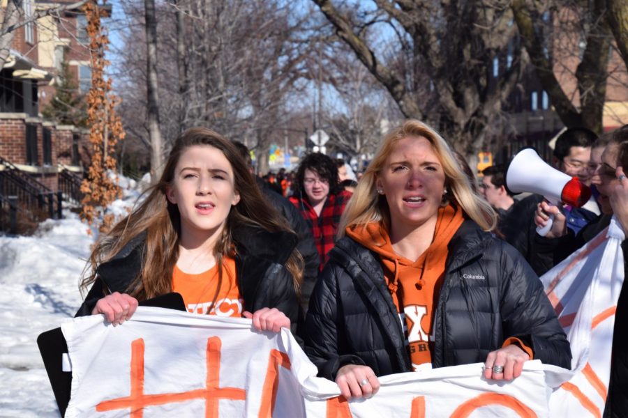 Junior Eva Goldfarb and senior Izzi Gilbert-Burke lead a chant during the student-led walkout, March 14. Students walked the 0.7 miles from St. Louis Park High School to Firehouse 1. 