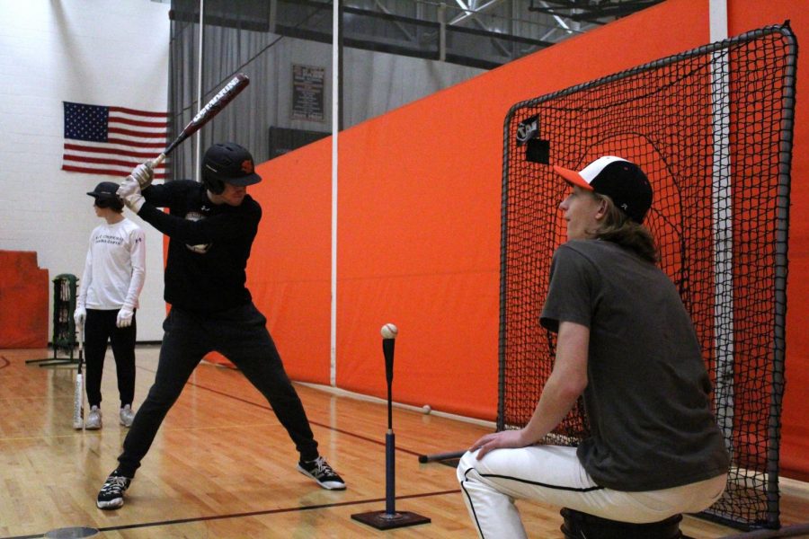 Senior Shea Pekarek takes practice swings using a tee during his tryout March 21.