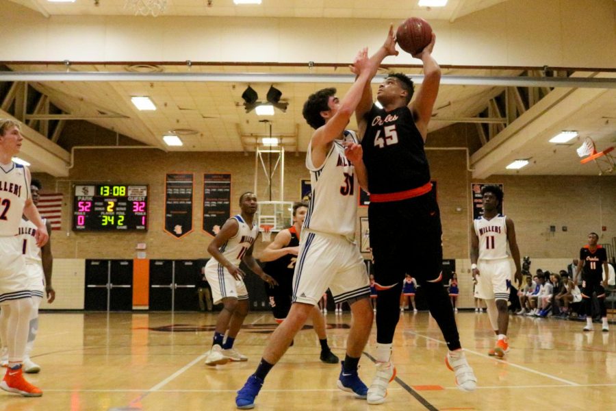 Junior Anthony Rayson posts up against Washburns Gavin Yares during the second half of Parks first section game Mar. 6. Park defeated Washburn 85-70 and will play at 7:00 p.m. March 9 at Osseo High School against Wayzata for a spot in the section finals.