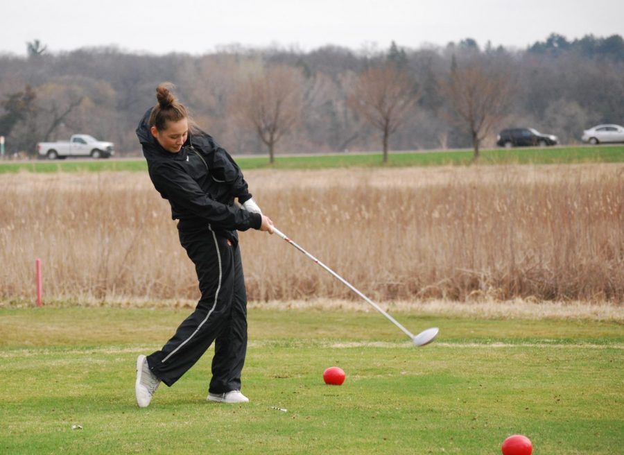 Freshman Izzy Segal hits the ball during a golf match at Theodore Wirth Park.