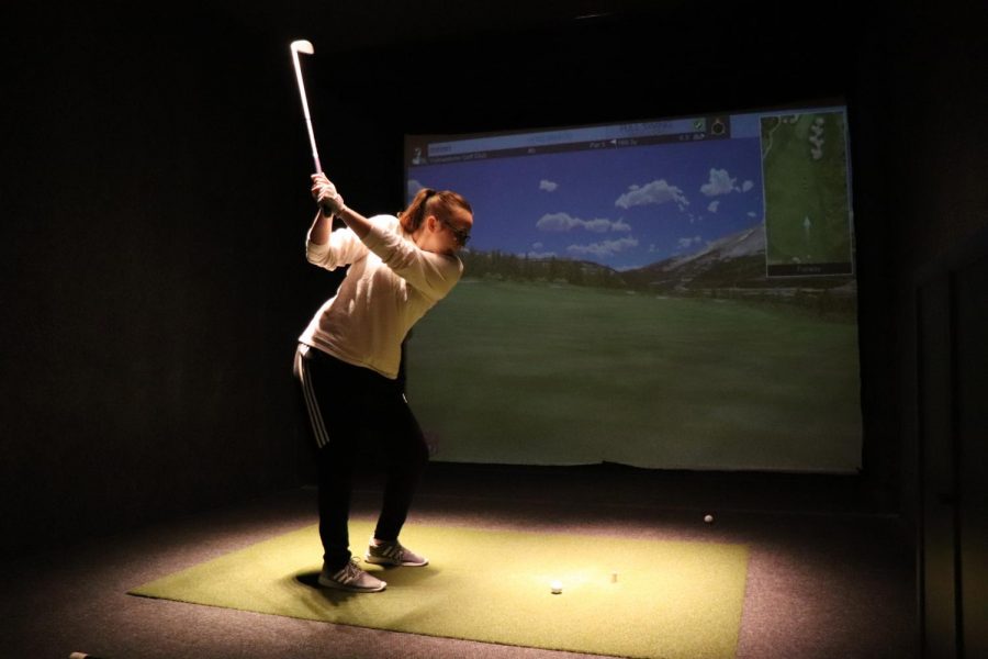 Girls golf captain senior Carly Livingston practices her swing indoors at the Life Time Fitness in Park. The teams has been practicing indoors due to the cold weather. 
