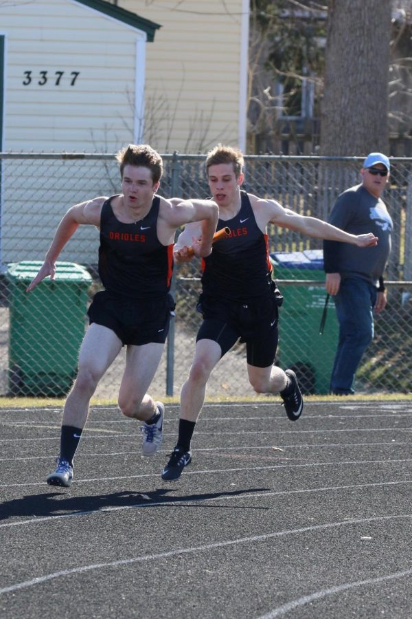Sophomore Jacob Brown hands off the baton to senior captain Skyler Rudelius-Palmer during the 4x200 race. Parked raced in their second meet of the season Thursday Apr. 26.