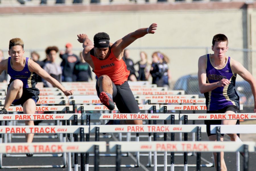 Senior Captain Peyton Morrison leaps over a hurdle during the 110m hurdle. This was Morrisons first meet of the season.