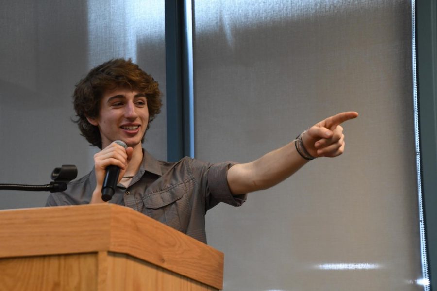 Senior Lukas Wrede points to his fellow Roots and Shoots members while the crowd applauds them for their work on the Climate Action Plan at their launch party April 22. The launch featured many speakers including St. Louis Park Mayor Jake Spano, Superintendent Astein Osei, Congressman Keith Ellison and several park high school students as well as students form the St. Louis Park class of 2025. 