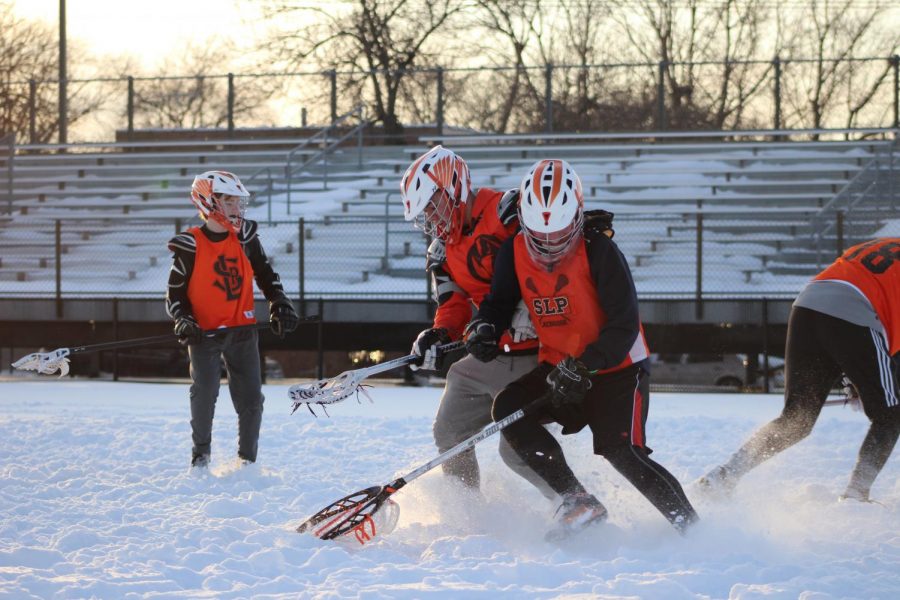 Boys lacrosse team conducts tryouts despite snow at Parks stadium. Tryouts took place April 2-5.