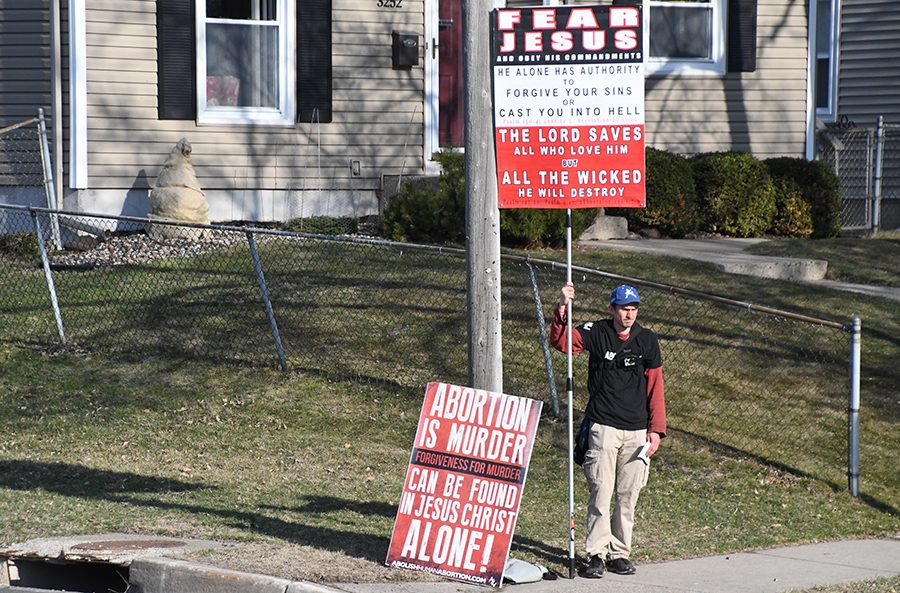 Anti-abortion protester Jeffery Stocker stands outside the high school on the corner of Edgewood and 33rd St. April 24. 