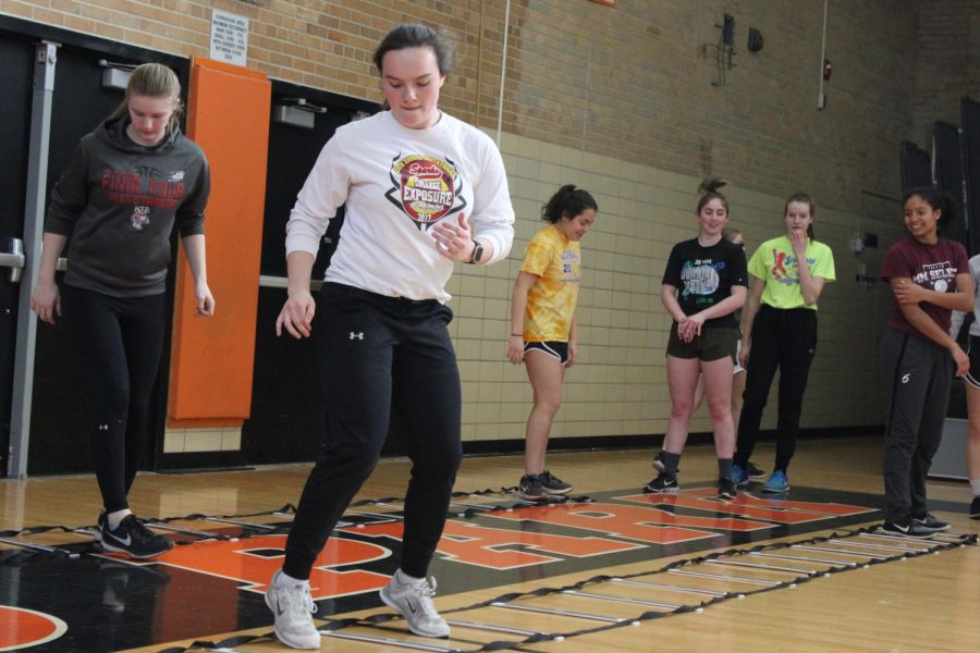 Senior varsity softball captain Annabelle Schutte runs a drill at practice March 16. Schutte pitches for Parks softball team.