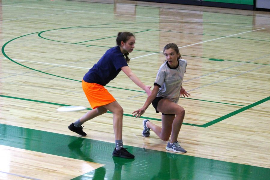 Sophomore Ally Feller kneels and throws a pass during the Edina Mixer tournament April 7.
