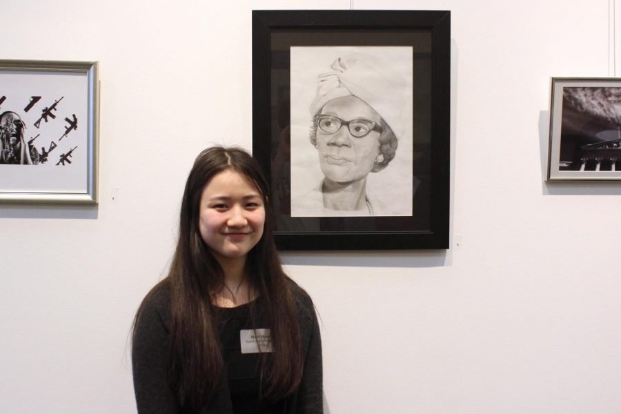 Mari+Hanchi+smiles+next+to+her+art+at+The+Congressional+Art+Competition+on+April+23.+She+won+second+place+for+her+artwork.