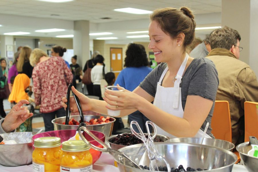 Founder of SEEDS Julie Rapperport serves fruit to students and community members April 24 in the St. Louis Park High School cafeteria. 