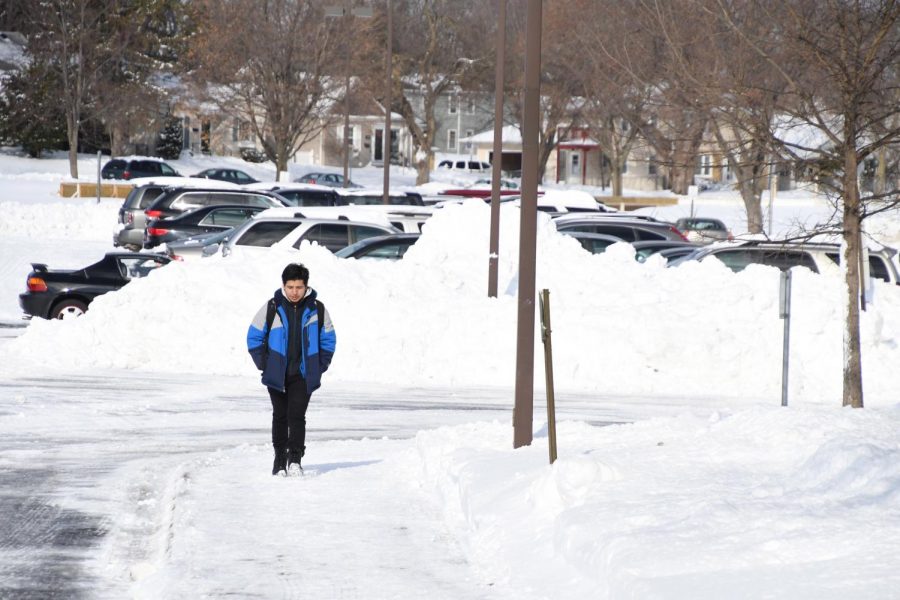 Senior Wilson Tamay Pineda walks through the snow into school April 16. Over the weekend St. Louis Park received roughly 17 inches of snow causing several surrounding districts to cancel school. 