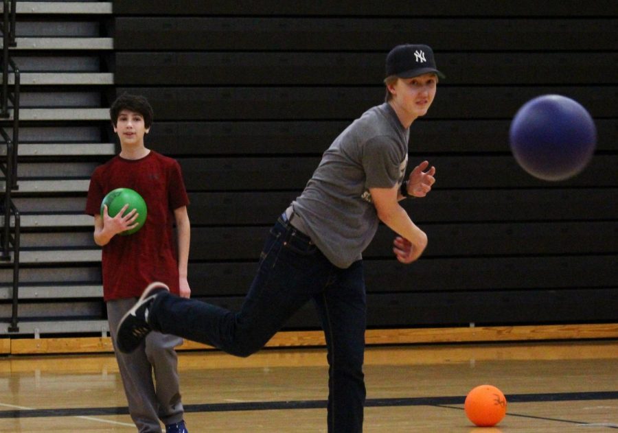 Senior Otis Walvatne throws a dodgeball at his opponents during the H2O Dodgeball Tournament fundraiser April 18. Walvatne joined with three other boys’ tennis players to form a team.