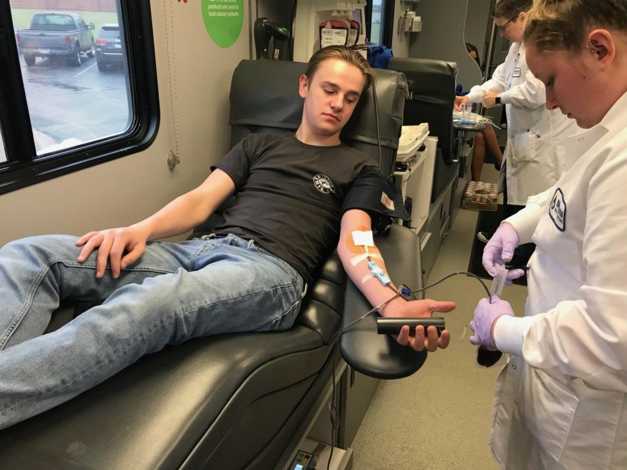 Junior Kyle Ballenger gets his blood drawn during the blood drive May 30. Students who donated were able to receive t-shirts and restaurant discounts following donation.