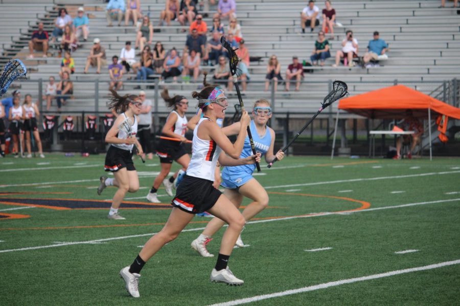 Senior Rosie Colacino runs the ball down the field looking to score during the girls lacrosse game May 24 against Bloomington Jefferson. The final score was 1-15.