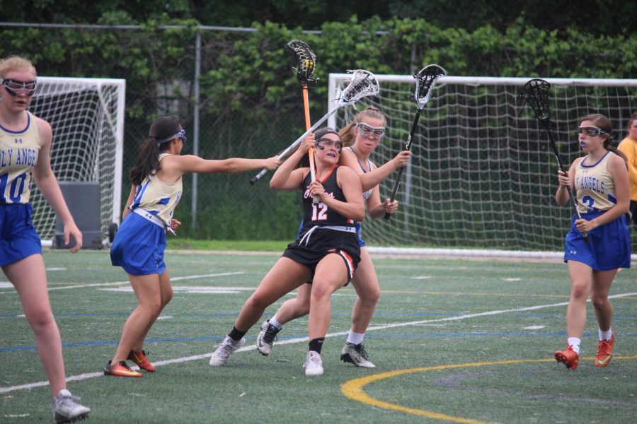 Sophomore Sarah McCallon protects the ball as she makes her way to the goal. Park played Holy Angels May 30.