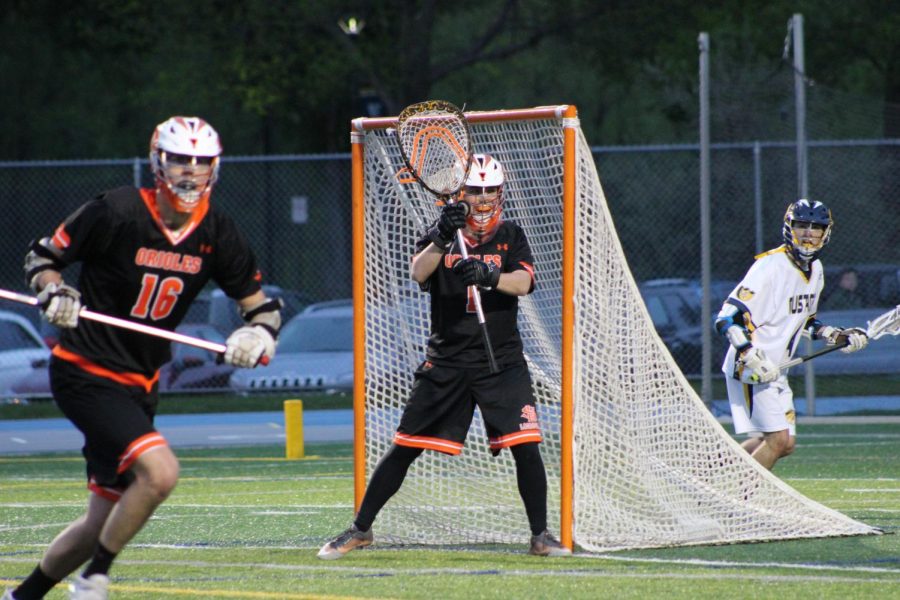 Junior Noah Houser attempts to block a shot in a game against Breck 7 May 11 at Breck School. Houser has been a goalie since he started playing lacrosse in middle school.