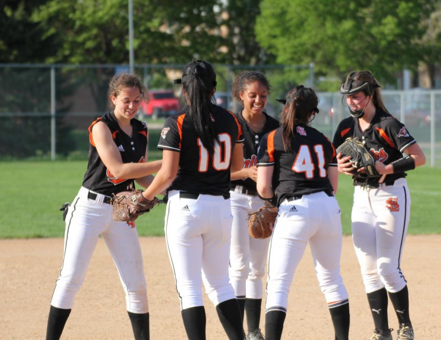 Park infielders celebrate after senior Annabelle Schutte strikes out a Benilde batter May 16. This was the last game of the regular season for varsity softball. 